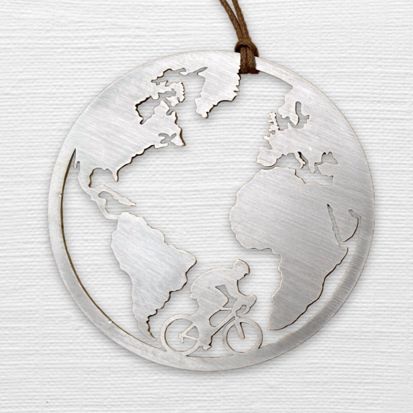 a metal ornament with a map of the world on it