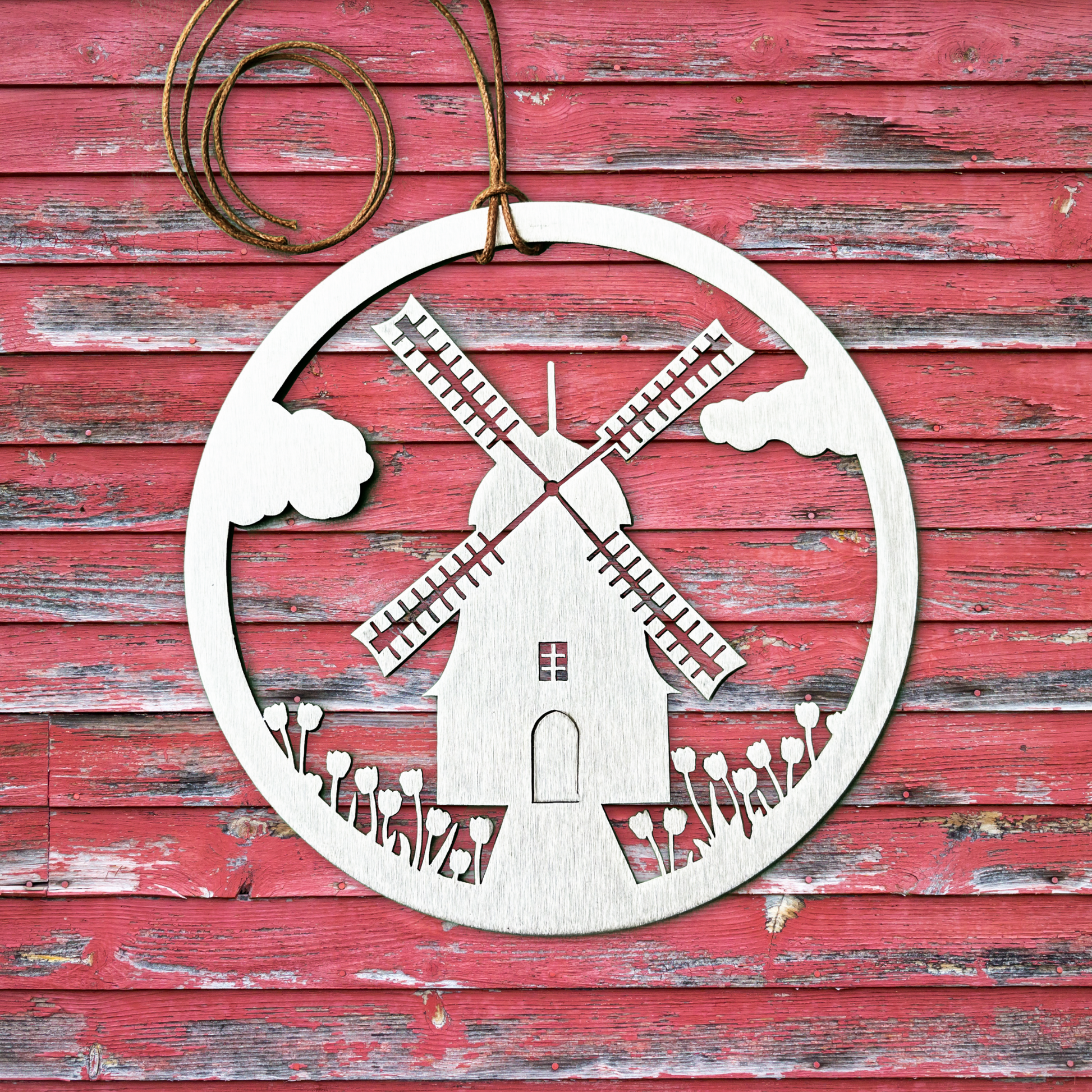 a wooden ornament with a windmill on it