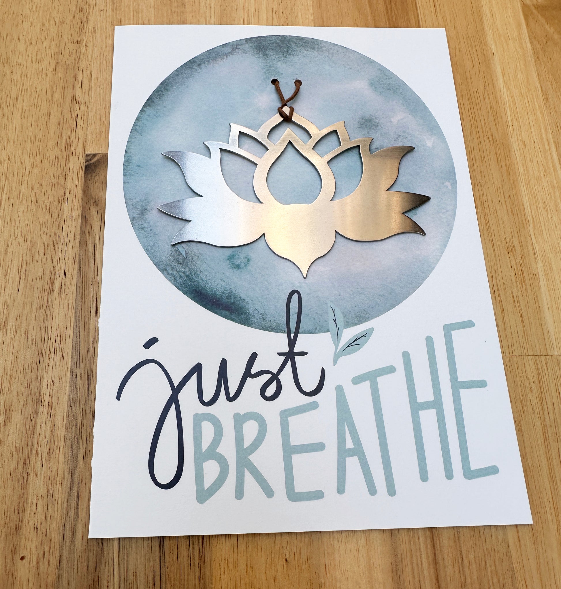 a greeting card with a metal lotus on it