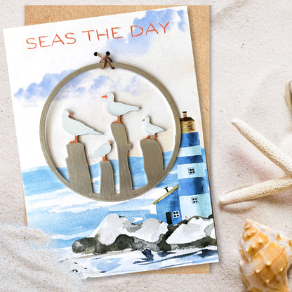 a card with a picture of a lighthouse and seagulls