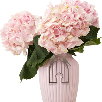 a pink vase with pink flowers in it