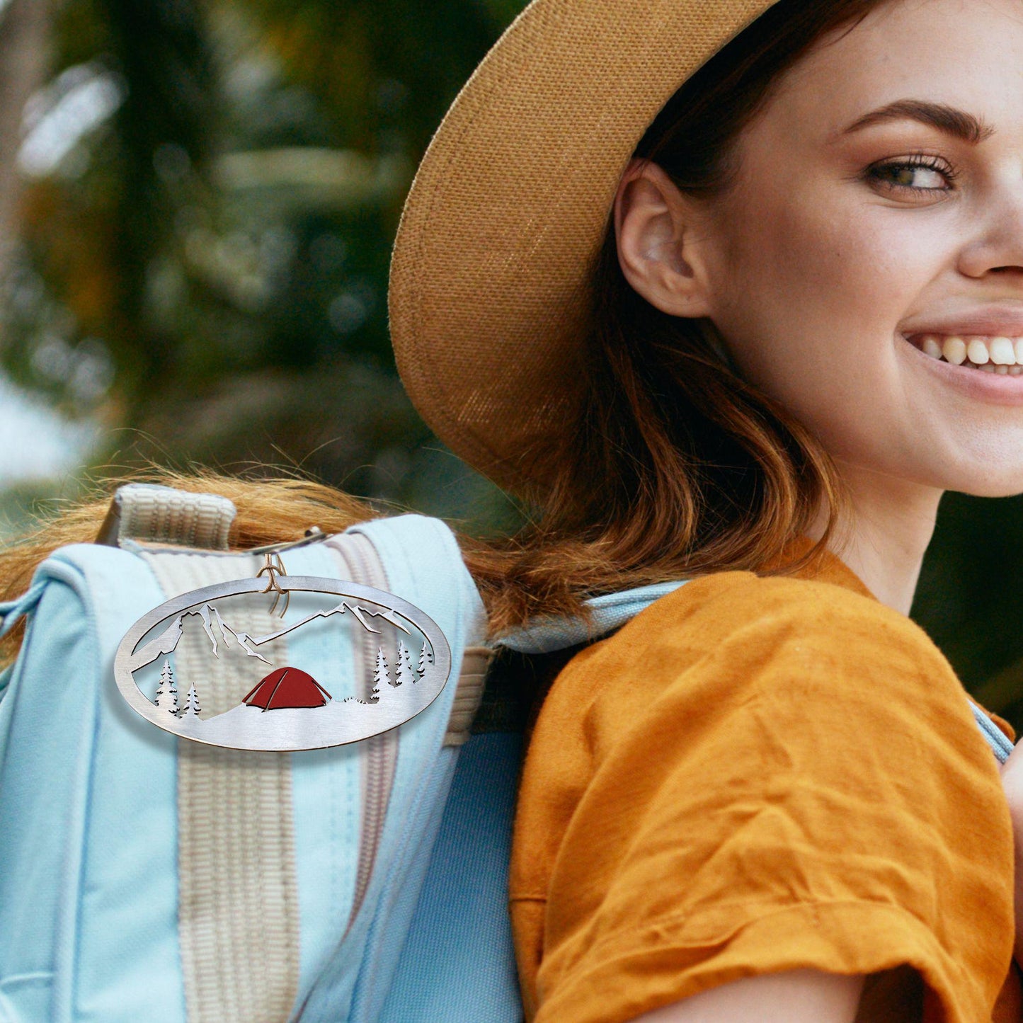 a woman wearing a hat and a backpack